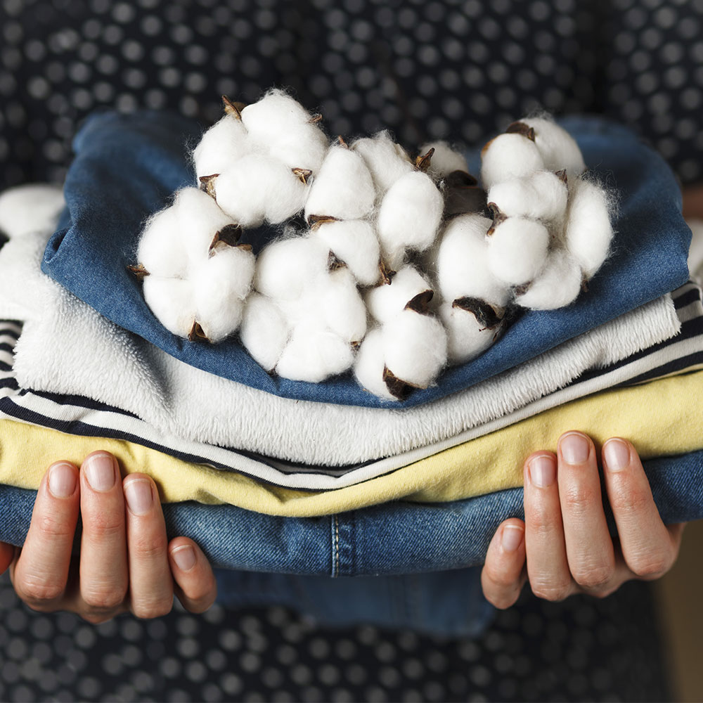 pile of clothes topped with cotton balls
