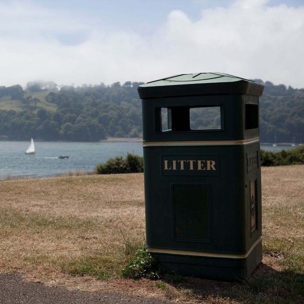 a public litter bin by a lake